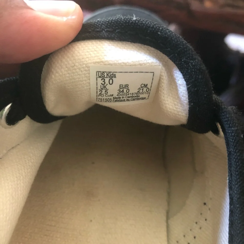 Vans all black kids lace up skateboard shoes.